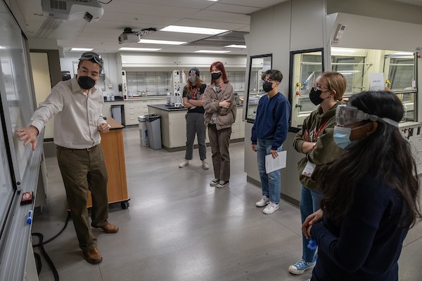 Student touring a science lab on Miami's campus